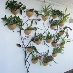For the orchid lovers, I designed this vertical orchid tree. The metal frame mimics the shape of a tree, allowing you to display multiple orchid plants on a single wall, turning them into a stunning floral feature.