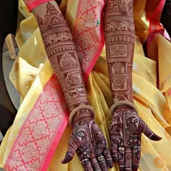 The beautiful mahogany stain of a fully developed bridal mehndi. The intricate details of the story panels are crisp and clear, showcasing the quality of the henna.