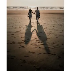Walking into the sunset, their shadows stretch out before them. This is a powerful and romantic image about walking into a new life together.