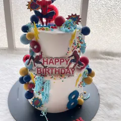 This two-tier Spider-Man cake was an action-packed centerpiece for an 8th birthday. I used multiple Spidey figures, sprinkles, and web details to create a dynamic and fun design.