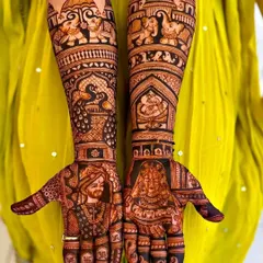 A full bridal design featuring lifelike portraits of the bride and groom. Notice the intricate details in the clothing and the traditional Rajasthani elements like elephants and palaces on the arms.