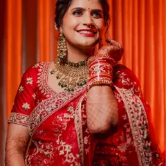 The getting ready moments are full of emotion. This North Indian bride's happy smile as she puts on her jewelry shows the excitement building up before she walks down the aisle.