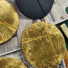 We believe in adding a personal touch to our spaces. These circular wall art pieces were designed and crafted in our own studio for a client's home. Made with wood, vegetable dyes, and gold and silver leaf, they represent the phases of the moon and add a layer of bespoke artistry to the interior.