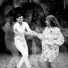 An artistic motion blur shot in black and white. This technique captures the energy and movement of the couple dancing, creating a dynamic and expressive portrait.