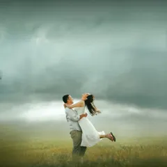 A moment of pure, unscripted joy. I encourage couples to be themselves, and this joyful lift against a dramatic, cloudy sky showcases the energy and connection that make for unforgettable pre-wedding photographs.