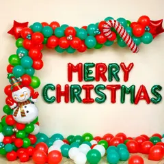 This is a classic Christmas decoration I set up for a client's home. It features a vibrant balloon garland arch in red and green, "Merry Christmas" foil letters, and charming details like a candy cane and a snowman foil balloon.