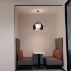 This private meeting nook is an example of how I create quiet zones in busy offices. The high-back upholstered seating helps to block out ambient noise and provide speech privacy.