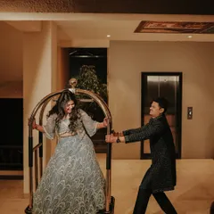 A fun and spontaneous moment of the groom pushing his laughing bride on a luggage cart. This playful shot perfectly captures the couple's fun-loving spirit and the joy of their wedding journey.