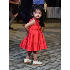 Bianca's little sister in a sweet raw silk Ikat frock. The pleated design and simple bow detail make it a comfortable and cute choice for a party.