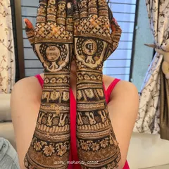 This heavy Indian mehendi design for the back of the hands features dense, elaborate patterns. The central peacock motif is surrounded by intricate checks and floral bands, extending all the way up the arm.