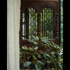 Detail of a reclaimed traditional wooden window frame, which we incorporated into the design. This element adds a layer of history and craftsmanship to the modern space.