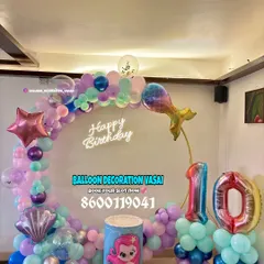 A mermaid theme for a 10th birthday. This ring setup features pastel balloons, mermaid tail and seashell foil balloons, and a themed cake plinth.