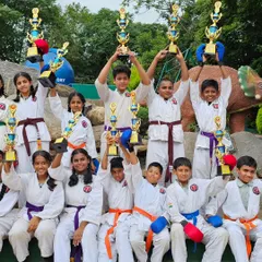The joy of a team victory. Students holding their trophies high, a testament to their collective effort and the supportive environment at our academy.