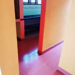 Another view of the kitchen entrance, showing the red trim and shelving against the lighter orange walls. We can handle multi-color interior designs.