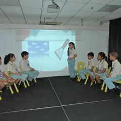 Students participate in a visual spelling round, connecting images with words. This multi-sensory approach to language helps reinforce learning and makes it more engaging for everyone.