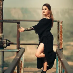 Black with a little gold. This shot, taken on a rusty industrial platform overlooking a valley, blends a tough, edgy aesthetic with the beauty of the natural landscape.