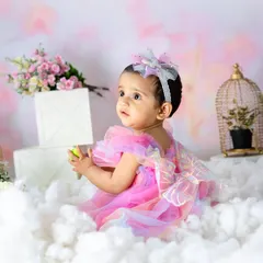 Lost in a whimsical world of pink clouds and flowers. I use soft lighting and delicate props to create these enchanting fairy-tale portraits for toddlers.