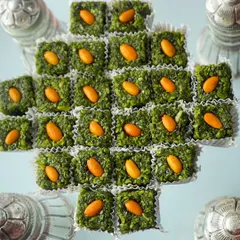 A clean, focused shot of the gourmet pistachio sweets. Topped with an almond, these bites are a perfect blend of tradition and premium quality, making them a favorite for wedding celebrations.