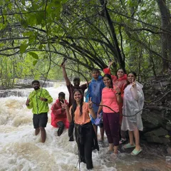 A fun group moment, wading through a rushing stream together. This is what adventure and friendship look like.