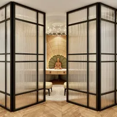 A 3D concept for a serene meditation corner, featuring a Buddha statue set in a beautifully lit niche and separated by fluted glass partitions.