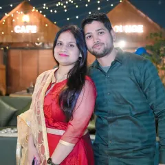 A sweet portrait of a couple at an outdoor cafe-style venue during a family gathering.