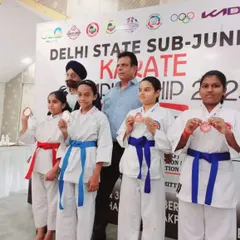 My female students showing their medals from the kumite and kata events. I place a special emphasis on empowering girls to be strong, confident, and competitive.