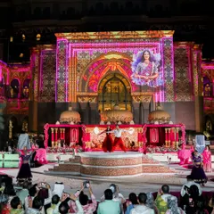 A sangeet performance set against a royal palace, with the bride's image projected onto the historic architecture. I blend technology and tradition to create layers of personal touches, making the celebration uniquely yours.