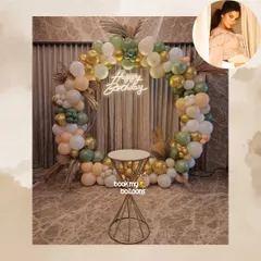 I design custom balloon arrangements to fit any aesthetic. This full balloon ring in muted tones of sage green, peach, and gold creates an elegant and modern photo backdrop.