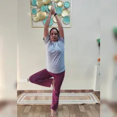 A student holds Vrikshasana (Tree Pose), a wonderful asana for improving balance, focus, and strengthening the leg muscles.
