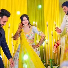 A happy bride showing off her henna while dancing with friends and family. Our mehndi is made to be a part of your celebration's energy and fun.
