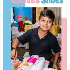 A proud young artist showing off his custom-painted canvas shoes. This activity is not just fun, it gives every guest a cool, personalized party favor to take home.