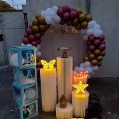 My circular backdrops are highly versatile for any celebration. This rooftop setup features a balloon arch in maroon, gold, and white, which can be used for a bridal shower, baby shower, or birthday, with props like the 'BABY' blocks easily swapped to fit your event theme.