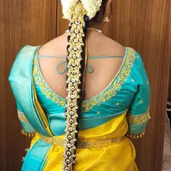 A back view of a bride wearing a stunning pearl and Kemp stone 'Jade Bangara'. This hair accessory adds so much grace and detail to the overall look.