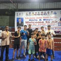 Posing with the team of young winners. As a coach, my greatest reward is seeing my students achieve their goals and stand proud with their medals.