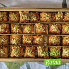 My homemade Square Baklava, a bestseller. Each piece has layers of flaky phyllo dough filled with chopped pistachios and almonds, sweetened with a delicate jaggery and honey syrup, and topped with more nuts.