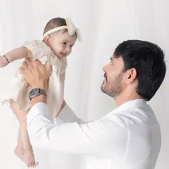 A father's love, lifting his daughter up. The joy and trust in her eyes as she looks at her dad is beautiful.