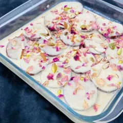 A modern twist on a classic dessert. This is our special Rasmalai, where the sweet cheese patties are garnished with pistachios, almonds, and dried rose petals for a beautiful and flavorful finish.