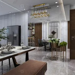 The dining area of the Rajasthali Apartments project, with a marble-top table and a modern chandelier. The open-plan layout connects it to the living space and a bar nook.