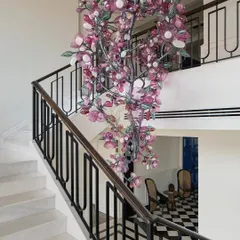 This custom 13-foot cherry blossom chandelier is the magical centerpiece of an 11,000 sq ft South Bombay home. It cascades down the staircase, transforming a functional area into a breathtaking design statement. It’s these one-of-a-kind details that bring a client's unique story into their home.