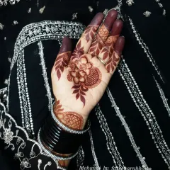 The deep color on the fingers and palm is a sign of high-quality, all-natural henna.