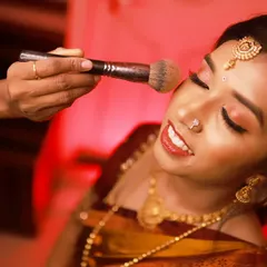 A behind-the-scenes moment of me applying finishing powder for Lavanya's engagement look, ensuring it's perfect and long-lasting.