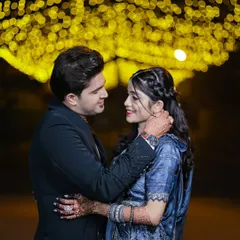 A romantic couple portrait under a canopy of fairy lights. The beautiful bokeh effect creates a dreamy, intimate atmosphere perfect for a reception shoot.