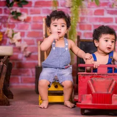 Double the fun with our setups designed for twins. This rustic schoolhouse theme, featuring a brick wall, vintage wooden desk, and a classic red toy truck, provides a charming backdrop for capturing the unique bond between siblings.