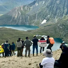 We made it. The feeling of reaching the summit with the group, overlooking a turquoise lake, is indescribable. A moment of shared accomplishment and awe on our Kashmir trek.