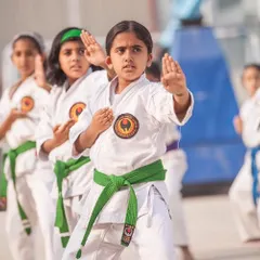 Focus is the foundation of karate. Here, a young green belt student demonstrates her concentration while practicing kata. We start training children from age 5, instilling discipline and an anti-bullying attitude from the very beginning.