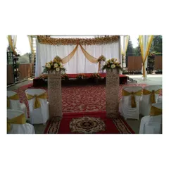 A beautiful terrace event setup. We used a red carpet aisle, crystal pillars, and elegant seating with gold sashes to create a formal and celebratory atmosphere for this lockdown event.