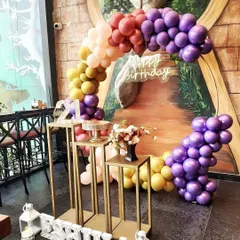 I love working with unique color combinations to make your birthday decor stand out. This beautiful balloon arch uses a sunset palette of purple, yellow, and orange for a truly memorable 21st birthday celebration at a local cafe.