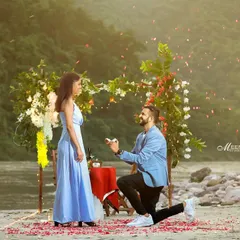 A beautiful surprise proposal captured on the banks of the Ganga. I help set up these perfect moments, complete with a floral arch and falling rose petals, to make your proposal truly unforgettable.