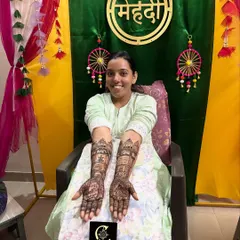 Seeing a happy bride is the best part of my job. Here is a full view of a custom bridal mehendi, extending from the palms to the elbows, with a smiling bride at her mehendi ceremony in Mumbai.