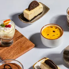 A curated selection of our finest desserts. From the rich Classic Tiramisu and Midnight Oreo Cheesecake to the delicate Smoked Caramel Crème Brûlée and Vanilla Mascarpone Bliss, our desserts are crafted to be the highlight of your event.